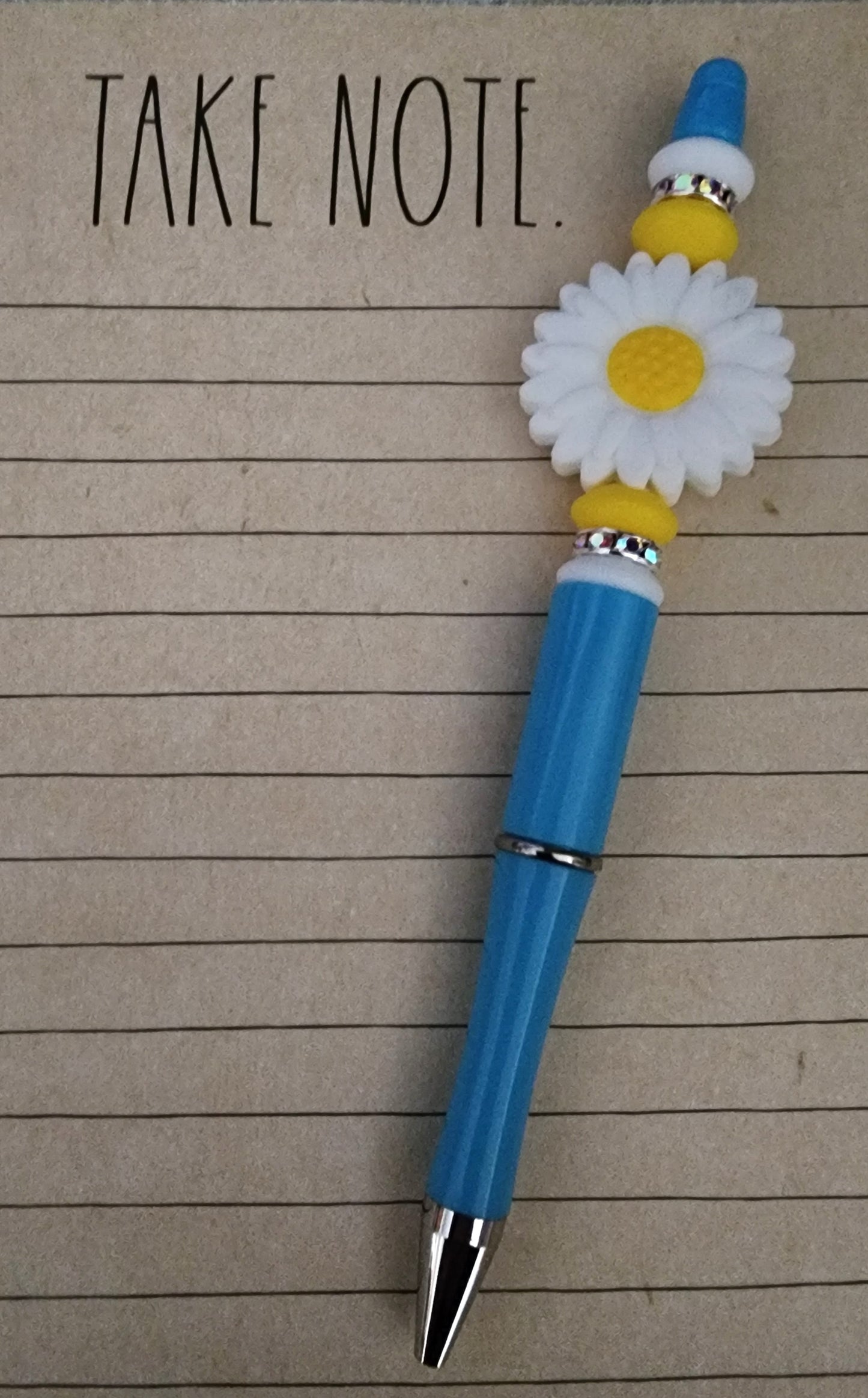White Daisy with White and Yellow Lentils Blue Pen